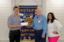 Caleb Brown, a teacher at Highlands School, and Assistant Principal Alyssa DeBois, accept a check from President Foster. The money is to be used by teachers for classroom supplies.